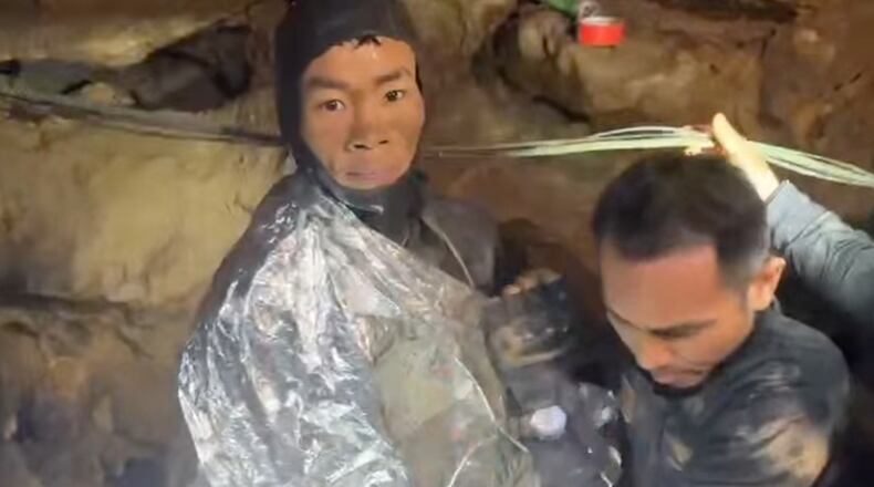 This video grab provided by Metta Tham Rescue Kalasin, shows rescuers evacuating the first of five villagers, left, who had been trapped in a cave in Xaisomboun province, Laos, Friday, May 29, 2026. (Metta Tham Rescue Kalasin via AP)