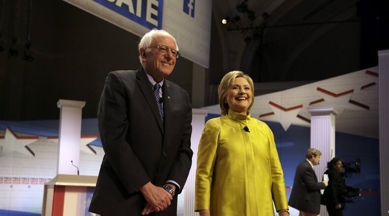 Democratic presidential candidates Sen. Bernie Sanders, I-Vt, left, and Hillary Clinton take the stage before a Democratic presidential primary debate at the University of Wisconsin-Milwaukee, Thursday, Feb. 11, 2016, in Milwaukee. (AP Photo/Tom Lynn)