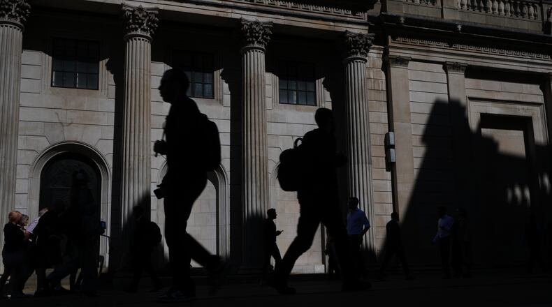 FILE -Pedestrians walk past the Bank of England in London, April 30, 2026. (AP Photo/Kirsty Wigglesworth, File)