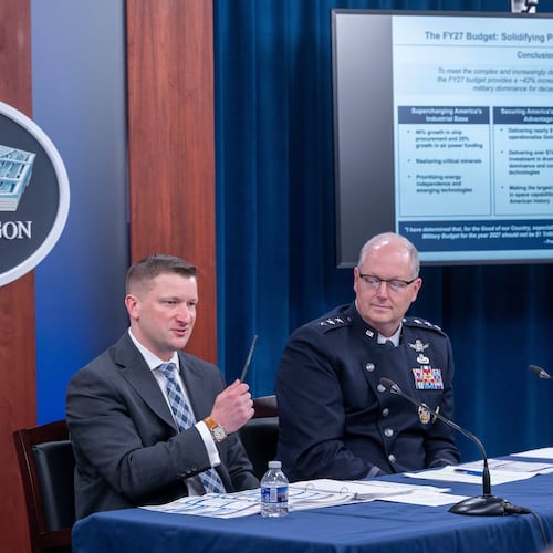 Acting Under Secretary of Defense and Comptroller, Jules Hurst III, left, and Director of Force Structure, Resources and Assessment of the Joint Chief of Staff Space Force Lt. Gen. Steven Whitney, talk with members of the media during a briefing on the Department of Defense's FY27 Budget Request at the Pentagon, Tuesday, April 21, 2026 in Washington. (AP Photo/Kevin Wolf)