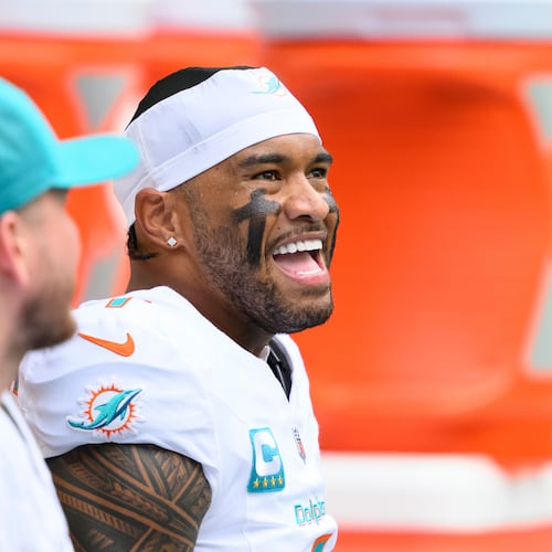 FILE - Miami Dolphins quarterback Tua Tagovailoa smiles on the bench during an NFL football game against the New Orleans Saints, Nov. 30, 2025, in Miami Gardens, Fla. (AP Photo/Doug Murray, File)