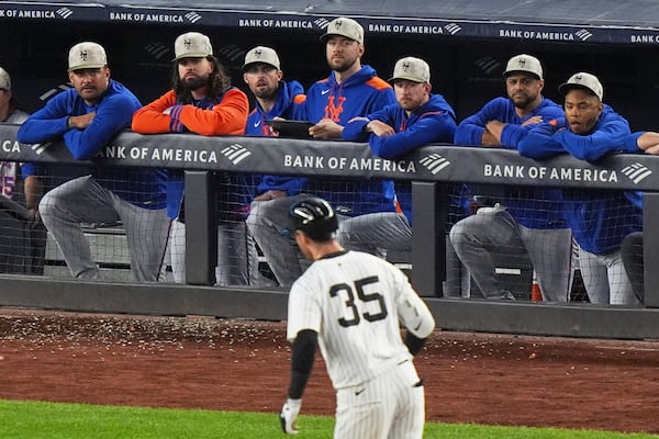New York Mets players watch as New York Yankees' Cody Bellinger (35) runs the bases after hitting a grand slam home run during the eighth inning of a baseball game Sunday, May 18, 2025, in New York. (AP Photo/Frank Franklin II)