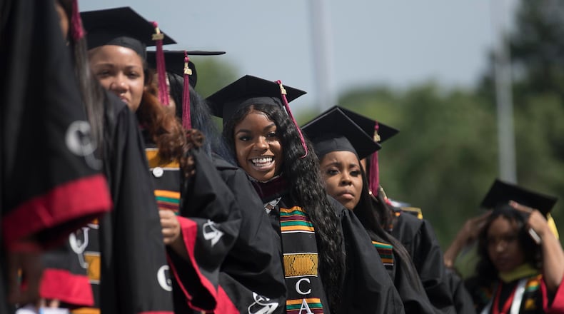 Proud graduates line up on stage before receiving their degree during Clark Atlanta University's 30th annual commencement ceremony at Panther Stadium in Atlanta, Monday, May 20, 2019. Its enrollment is about 4,000 students, the largest of any historically black college and university in Atlanta. (Alyssa Pointer/alyssa.pointer@ajc.com)