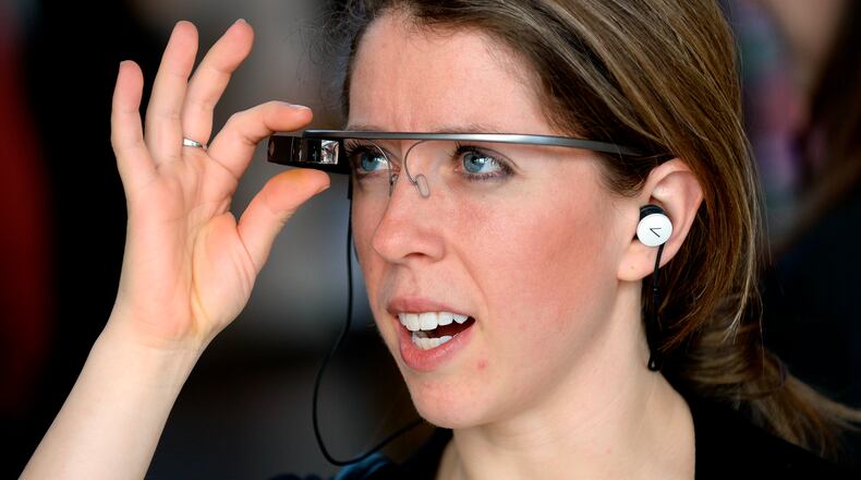 Sarah Cook uses voice commands to communicate with a Google Glass wearable computer headset during a demonstration at Puritan Mill in 2014, in Atlanta. Similar technology could radically revamp retail. David Tulis / AJC Special