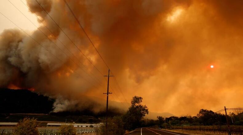 Smoke from the Santa Rosa and Napa Valley, Calif., wildfire covers the sun as the inferno rages through the area on October 10, 2017.