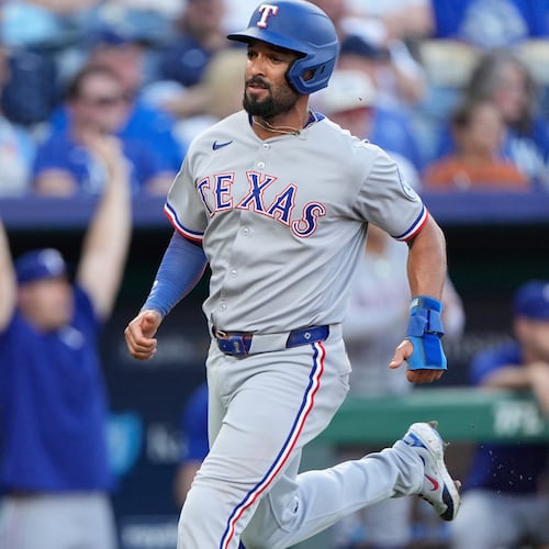 FILE - Texas Rangers' Marcus Semien runs home to score on an RBI single hit by Jonah Heim during the second inning of a baseball game against the Kansas City Royals, Monday, Aug. 18, 2025, in Kansas City, Mo. (AP Photo/Charlie Riedel, File)