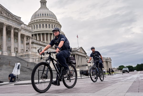 U.S. Capitol Police patrol the plaza as House Republicans work inside to pass President Donald Trump's signature bill of tax breaks and spending cuts by a self-imposed Fourth of July deadline, at the Capitol in Washington, Wednesday, July 2, 2025. (AP Photo/J. Scott Applewhite)