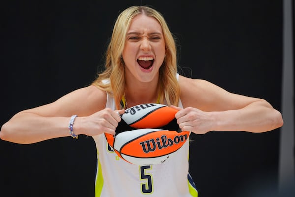 Dallas Wings guard Paige Bueckers (5) poses for photos during a WNBA basketball media day in Arlington, Texas, Wednesday, May 7, 2025. (AP Photo/LM Otero)