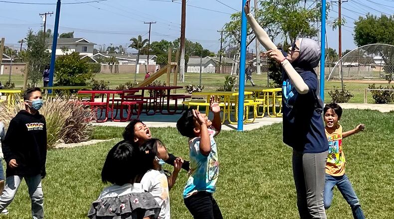 A Boys and Girls Club of Buena Park staff member plays ball with a group of students. The club is partnering with the school district to reduce chronic and excessive absenteeism.
(Linda Jacobson)