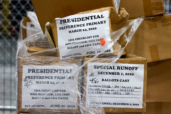 Boxes of election records not seized by the FBI during its January raid remain locked in a cage at the Fulton County Clerk's Warehouse behind the Fulton County Election Hub and Operation Center. (Arvin Temkar/AJC)