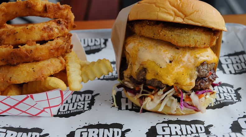 Grindhouse Dixie Style burger with pimento cheese, fried green tomato, Carolina cole slaw and chipotle ranch at Grindhouse Killer Burgers. / AJC file photo