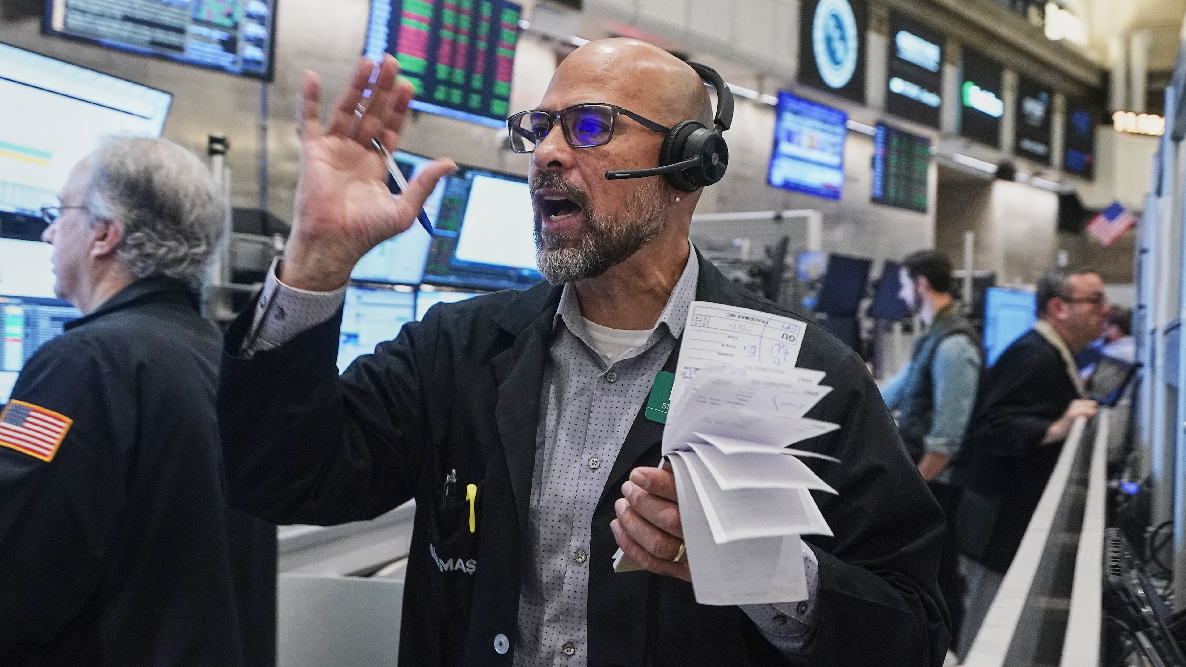 Options trader Steven Rodriguez works on the floor of the New York Stock Exchange, Friday, Nov. 21, 2025. (AP Photo/Richard Drew)