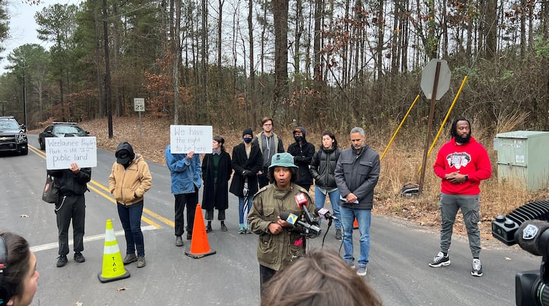Activist Jasmine Burnett, of Community Movement Builders, speaks to the media Wednesday, Dec. 14, shortly after the announcement that the GBI had charged five protesters of Atlanta's new public safety training center with domestic terrorism.