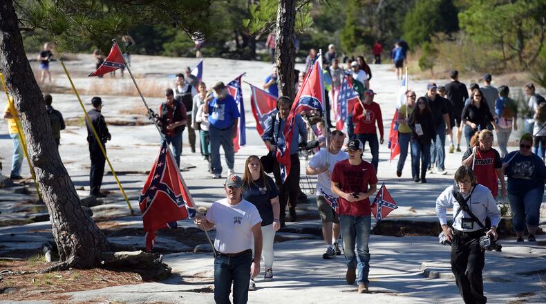 Pro-Confederate battle flag supporters head up the trail during a protest at Stone Mountain in November 201, after a proposal was made to place a monument on top of it dedicated to Martin Luther King Jr. Kent D. Johnson, kdjohnson@ajc.com