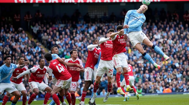 Manchester City's Erling Haaland heads the ball during the English Premier League soccer match between Manchester City and and Arsenal, in Manchester, England, Sunday, April 19, 2026. (AP Photo/Dave Thompson)