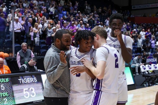 Darlington guard DJ Hall, center, celebrate with teammates after their 53-50 win against Holy Innocents’ in the Class 3A-A Private Boys GHSA State Championship at the Macon Coliseum, Wednesday, March, 11, 2025, in Macon, Ga. (Jason Getz/AJC)