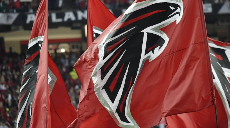 January 22, 2017, Atlanta - Falcons flags are flown after scoring a touchdown during the NFC Championship game against the Packers in Atlanta, Georgia, on Sunday, January 22, 2017. (DAVID BARNES / DAVID.BARNES@AJC.COM)