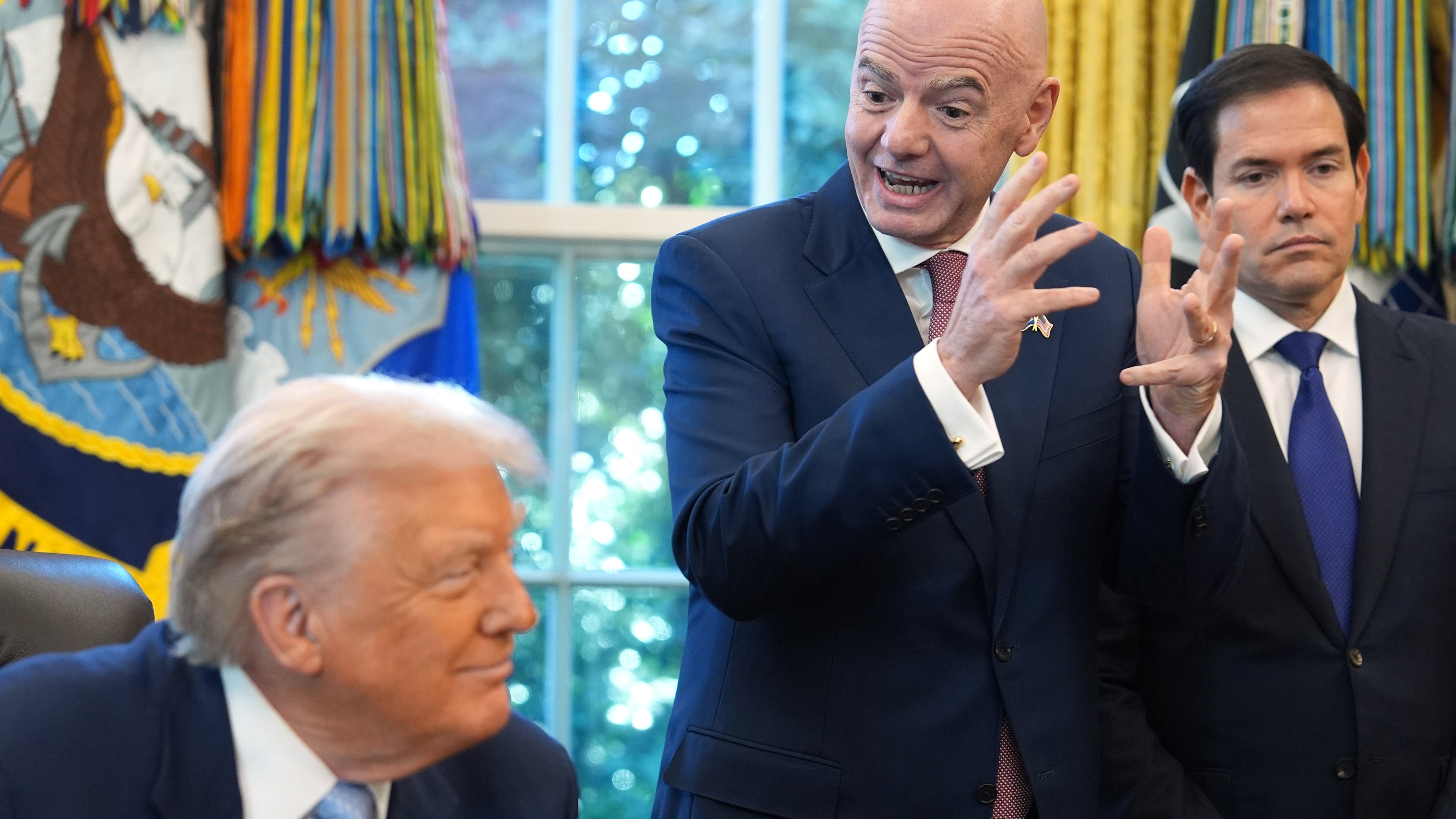 President Donald Trump and Secretary of State Marco Rubio listen as FIFA President Gianni Infantino speaks during a meeting with the White House task force on the 2026 FIFA World Cup in the Oval Office of the White House, Monday, Nov. 17, 2025, in Washington. (AP Photo/Evan Vucci)