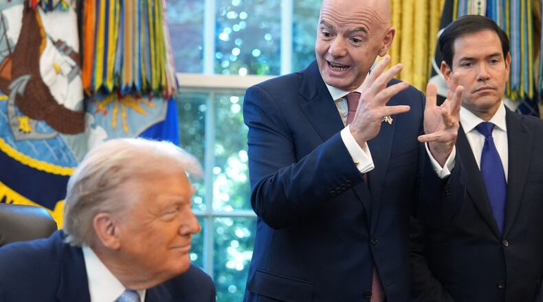 President Donald Trump and Secretary of State Marco Rubio listen as FIFA President Gianni Infantino speaks during a meeting with the White House task force on the 2026 FIFA World Cup in the Oval Office of the White House, Monday, Nov. 17, 2025, in Washington. (AP Photo/Evan Vucci)
