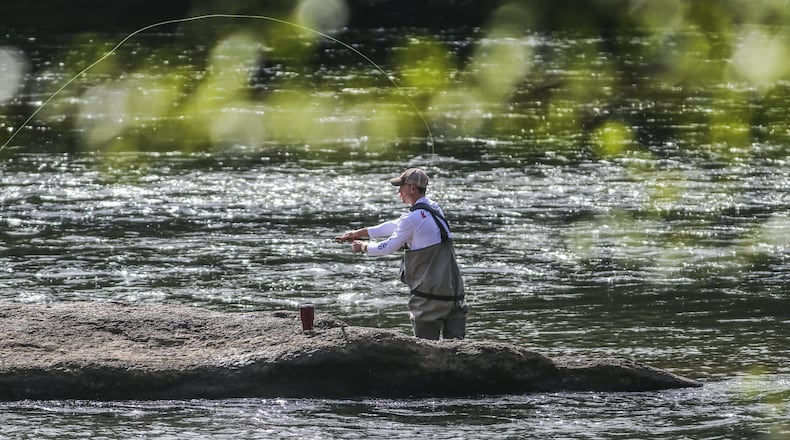 An Atlanta man fly fishes on the Chattahoochee River in Cobb County. The state last year increased the fees for fishing and hunting licenses. The additional money is being used to maintain public hunting and fishing areas and hire more game wardens. JOHN SPINK/JSPINK@AJC.COM