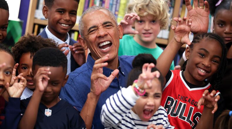 Former President Barack Obama poses for a photograph after reading to school children on opening day of the Barack Obama Presidential Center in John Lewis Plaza, Friday, June 19, 2026, in Chicago. (Win McNamee/Pool Photo via AP)