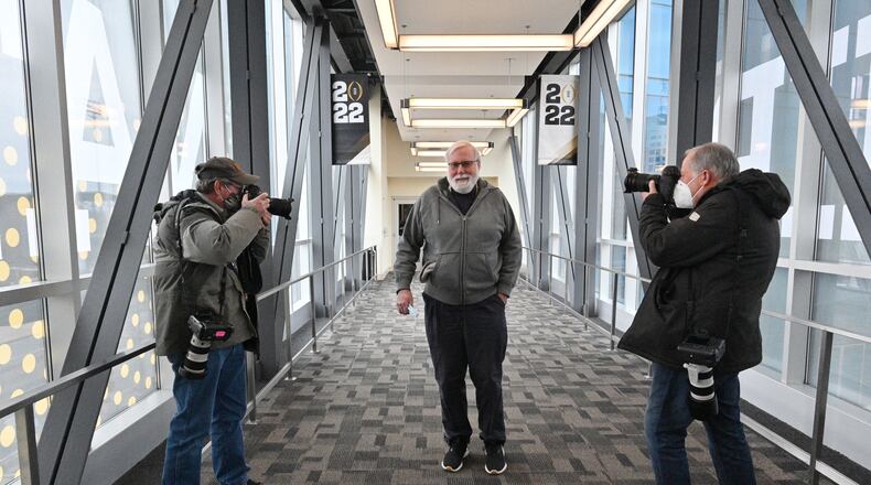 Atlanta Journal-Constitution Sports reporter Steve Hummer is photographed by AJC’s photojournalists Curtis Compton and Bob Andres in downtown Indianapolis on Sunday, January 9, 2022. Coverage of Georgia's victory in the College Football Playoff championship game was the final assignment for Hummer before he retired after nearly 38 years at the AJC. (Hyosub Shin / Hyosub.Shin@ajc.com)