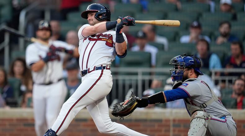 Atlanta Braves' Lane Thomas (20) hits a solo homerun against the New York Mets in the second inning of a baseball game, Wednesday, Aug. 12, 2026, in Atlanta. (AP Photo/Mike Stewart)