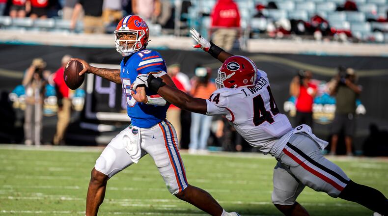 Gators quarterback Anthony Richardson tries to elude Bulldogs defensive lineman Travon Walker last season in Jacksonville, Fla. (Stephen B. Morton/Atlanta Journal-Constitution)