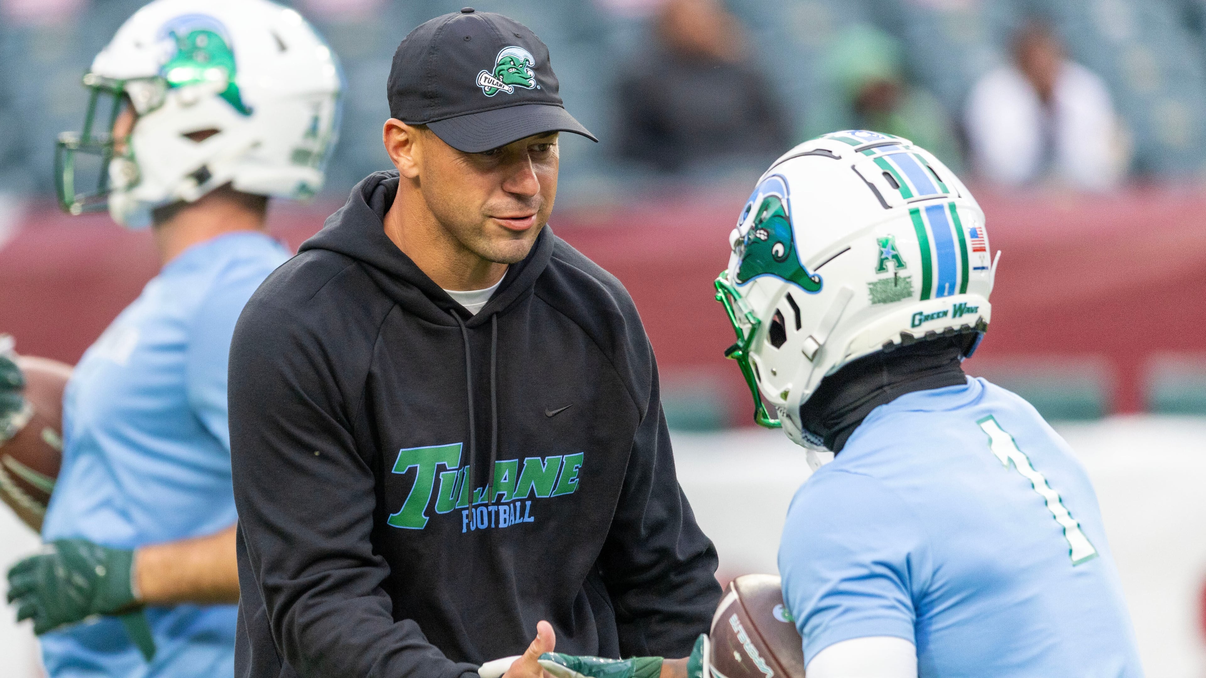 Tulane head coach Jon Sumrall, front left, talks to players before an NCAA college football game against Temple, Saturday, Nov. 22, 2025, in Philadelphia. (AP Photo/Laurence Kesterson)