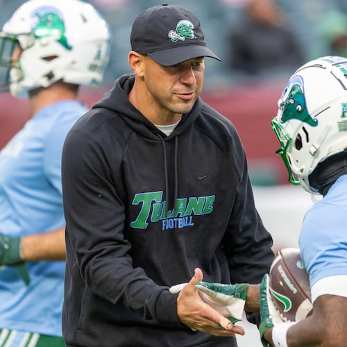 Tulane head coach Jon Sumrall, front left, talks to players before an NCAA college football game against Temple, Saturday, Nov. 22, 2025, in Philadelphia. (AP Photo/Laurence Kesterson)