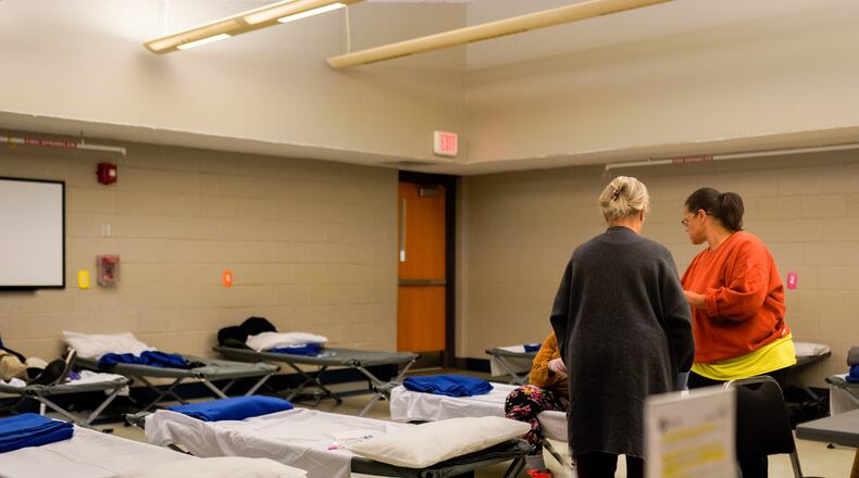 Residents of the warming station prepare to leave at the 7am departure time. The shelter and others like it are open the next four days as winter weather descends across the country. Friday December 23 2022 (Ben Hendren for the Atlanta Journal-Constitution)