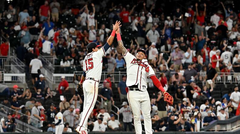 Braves second baseman Nicky Lopez (15) and shortstop Orlando Arcia (11) celebrate their win over New York Yankees at Truist Park, Tuesday, August 15, 2023, in Atlanta. Atlanta Braves won 5-0 over New York Yankees. (Hyosub Shin / Hyosub.Shin@ajc.com)