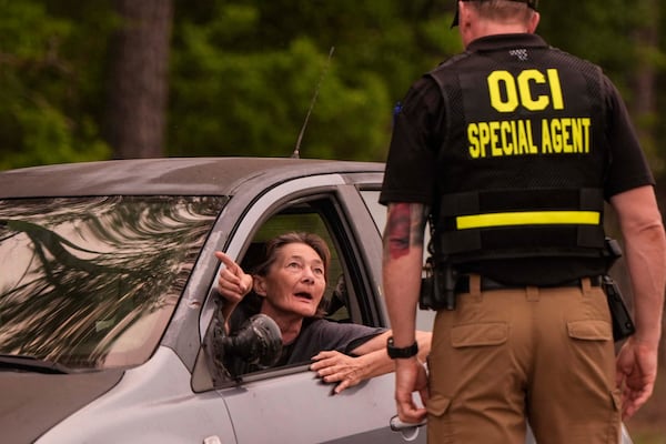 A woman speaks to a state official at a road block in Brantley County, Wednesday, April 22, 2026, near Nahunta, Ga. (Mike Stewart/AP)