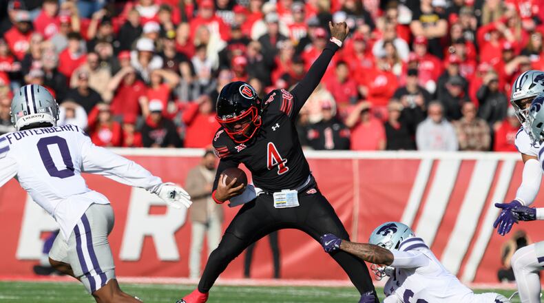 Utah quarterback Devon Dampier (4) is tackled by Kansas State defensive back Qua Moss, bottom right, during the first half of an NCAA college football game, Saturday, Nov. 22, 2025, in Salt Lake City. (AP Photo/Tyler Tate)