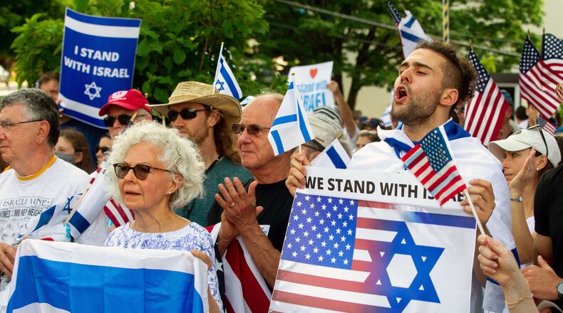 Roei Gilad (right) cheers during one of the speeches at a rally in support of Israel at the Israeli Consulate in Atlanta on Sunday, May 23, 2021. (Photo: Steve Schaefer for The Atlanta Journal-Constitution)