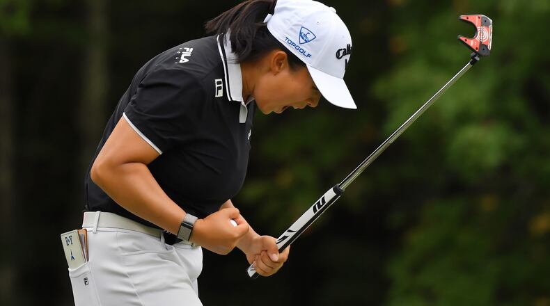Ruoning Yin, of China, celebrates after sinking her final putt on the 18th green to win the LPGA FM Championship golf tournament, Sunday, Aug. 30, 2026, in Norton, Mass. (AP Photo/Steven Senne)