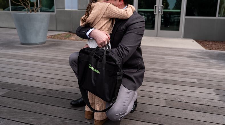 FILE - Milenko Faria, whose wife, Dr. Rubeliz Bolivar, is in immigration custody, hugs their daughter, Milena, after his asylum interview at the U.S. Citizenship and Immigration Services facility in Tustin, Calif., Thursday, April 16, 2026. (AP Photo/Jae C. Hong, File)