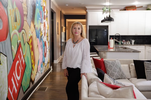 Lora Clemens poses for a photo inside one of her short-term rental properties in Atlanta on Thursday, May 1, 2025. (Natrice Miller/AJC)