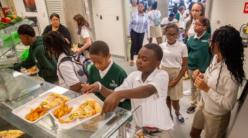 Students at Drew Charter School pick up their school lunch Friday, Aug. 9, 2019. STEVE SCHAEFER / SPECIAL TO THE AJC