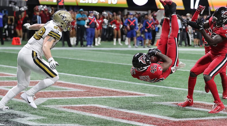 Atlanta Falcons linebacker Deion Jones intercepts New Orleans Saints quarterback Drew Brees' pass intended for tight end Josh Hill (left) in the end zone to hold on to a 20-17 victory on Thursday, Dec. 7, 2017, in Atlanta, Ga. (Curtis Compton/Atlanta Journal-Constitution/TNS)