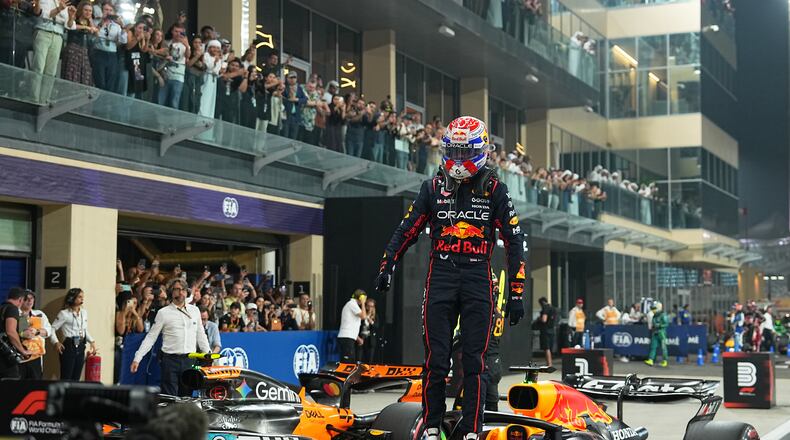 Red Bull driver Max Verstappen of the Netherlands celebrates after clocked the fastest time during the qualifying session ahead of the Formula One Abu Dhabi Grand Prix at the Yas Marina Circuit in Abu Dhabi, UAE, Saturday, Dec. 6, 2025. (AP Photo/Fatima Shbair)