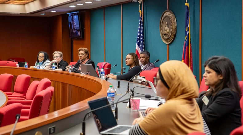 The Georgia House Democratic Caucus (GHDC), including State Representative Park Cannon, center, and State Representative & Minority Leader James Beverly, behind Cannon, gray suit, listen to testimonials from advocates, physicians and mothers on the current maternal mortality crisis Thursday, January 4, 2024 at the Coverdell Legislative Office Building. (Jenni Girtman for The Atlanta Journal-Constitution)