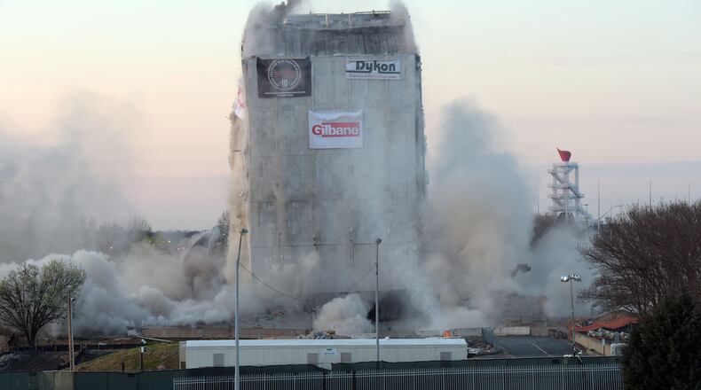 Demolition crews brought down the old state archives building in a controlled implosion shortly after 7 am Sunday, March 5, 2017.  The 14-story state archives building was about 50 years old and was imploded to make way for a new state courts building. Gov. Deal has budgeted about $105 million in next year's budget for the new state courts building. Kent D. Johnson/AJC