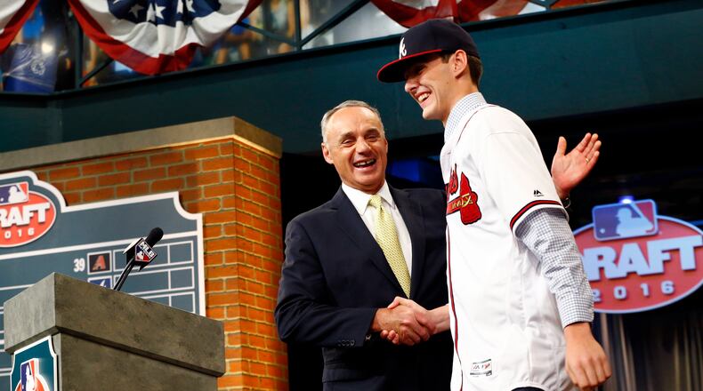 Baseball Commissioner Rob Manfred welcomes the Braves top draft pick last year, pitcher Ian Anderson, out of Shenendehowa High School in Clifton Park, N.Y. (AP Photo/Julio Cortez)