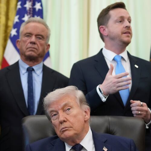 Chris Klomp, director of the Centers for Medicare and Medicaid Services, right, speaks as President Donald Trump and Health and Human Services Secretary Robert F. Kennedy Jr. listen during an event on health care affordability in the Oval Office at the White House, Thursday, April 23, 2026, in Washington. (AP Photo/Mark Schiefelbein)