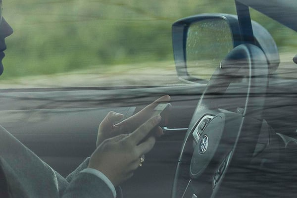 A person appears to be using their cellphone while driving on the Downtown Connector in Atlanta, Friday, February 7, 2020. (Alyssa Pointer/AJC) 