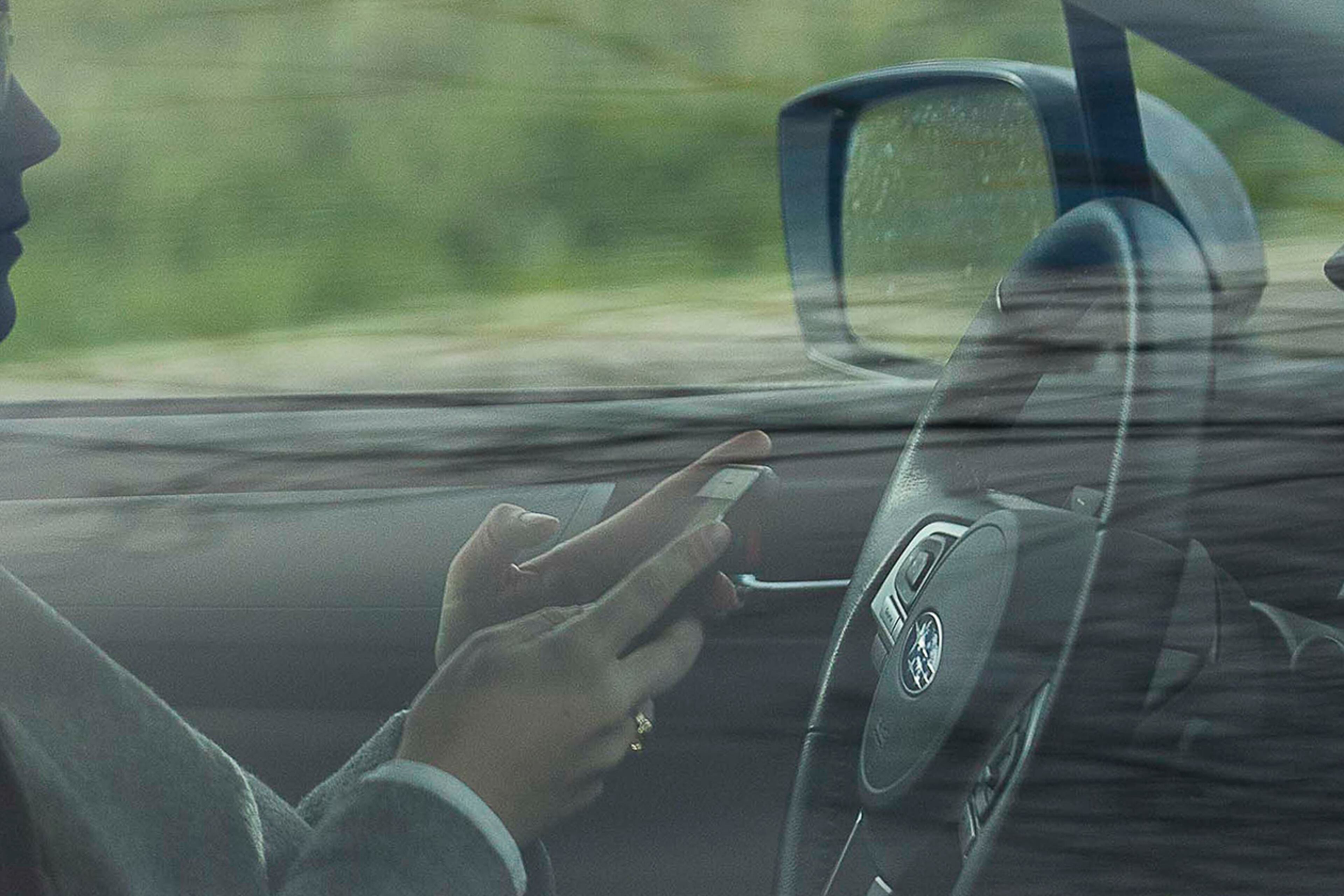 A person appears to be using their cellphone while driving on the Downtown Connector in Atlanta, Friday, February 7, 2020. (Alyssa Pointer/AJC)