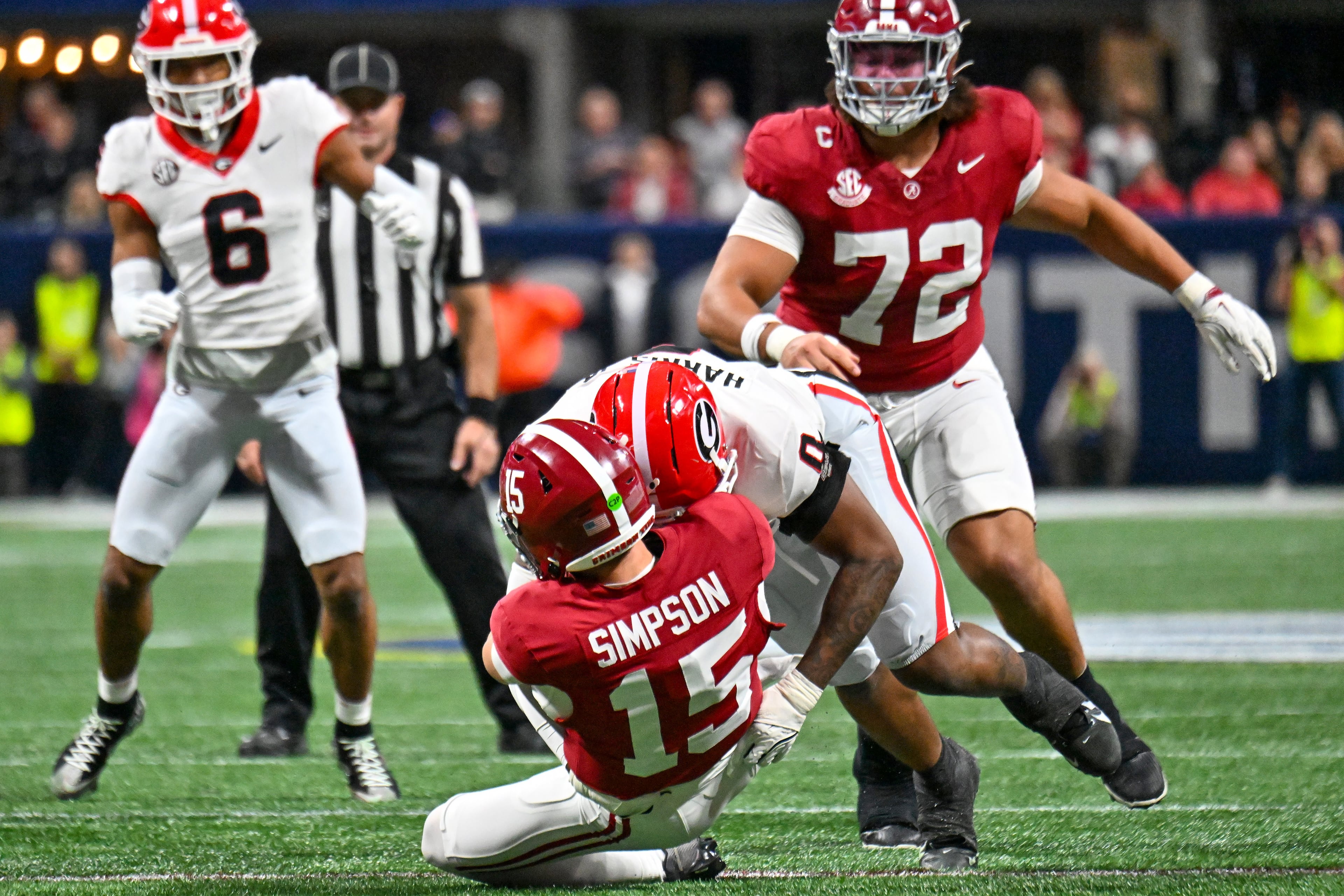Alabama quarterback Ty Simpson (15) is sacked by Georgia linebacker Gabe Harris Jr. (0) during the first quarter of the SEC Championship game at Mercedes-Benz Stadium, Saturday, Dec. 6, 2025, in Atlanta. (Hyosub Shin / AJC)