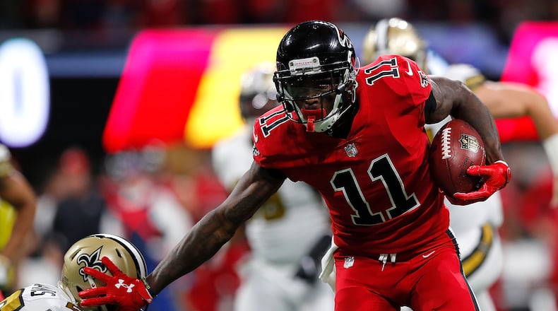 Falcons wide receiver Julio Jones, seen here stiff-arming P.J. Williams of the Saints after a reception at Mercedes-Benz Stadium on December 7 in Atlanta, had 12 receptions for 300 yards and a touchdown last season against Carolina.