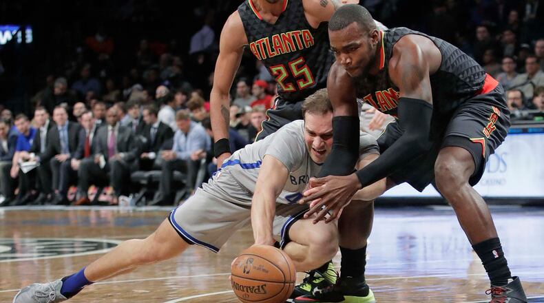 Brooklyn Nets’ Bojan Bogdanovic (44) and Atlanta Hawks’ Paul Millsap (4) vie for control of the ball during the first half of an NBA basketball game Tuesday, Jan. 10, 2017, in New York. (AP Photo/Frank Franklin II)